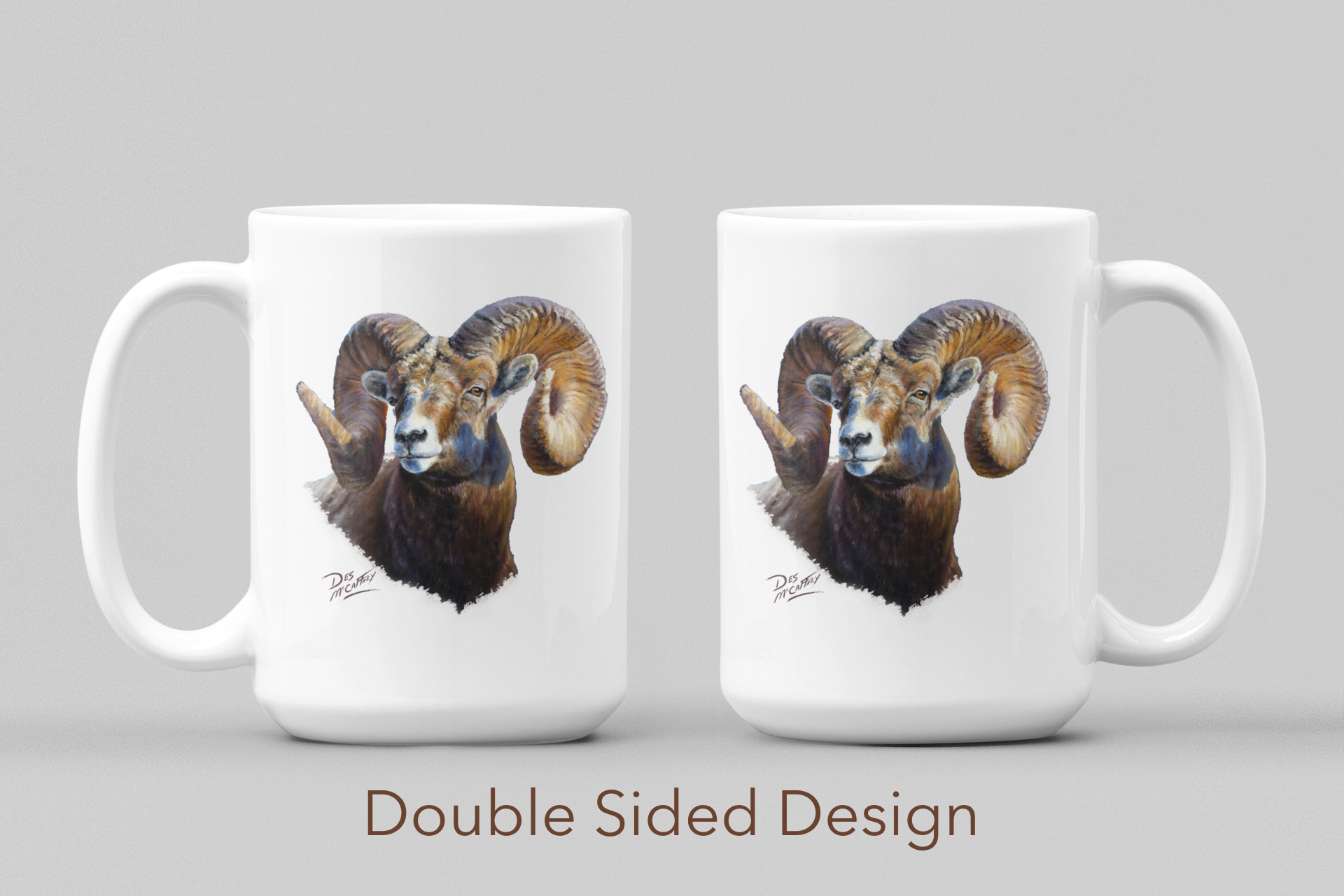 White ceramic coffee mug featuring a painting of a bighorn ram, artwork by Canadian wildlife artist Des McCaffrey, displaying both sides.