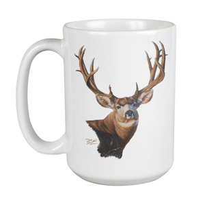 White ceramic coffee mug featuring a painting of a mule deer buck with large antlers, artwork by Canadian wildlife artist Des McCaffrey.