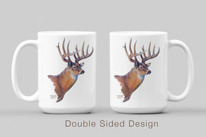White ceramic coffee mug featuring a painting of a whitetail buck with large antlers, artwork by Canadian wildlife artist Des McCaffrey, displaying both sides. 